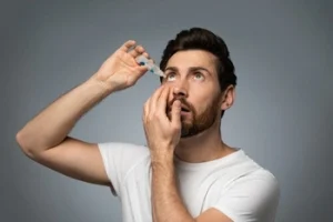 prk patient applying eye drops prk patient applying eye drops